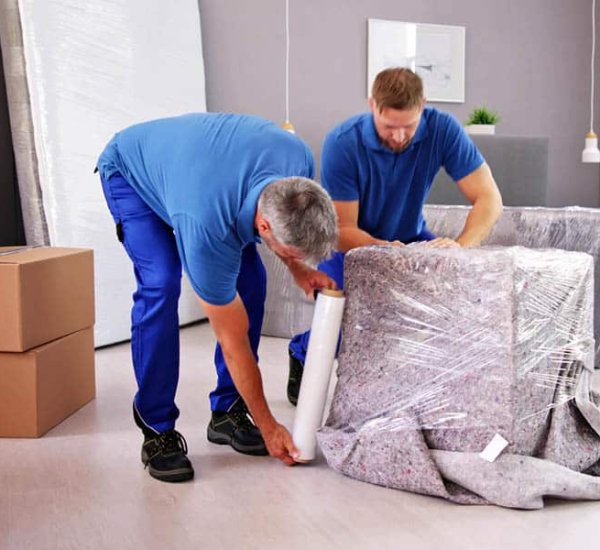 Titanium Relocation crew protecting furniture for a move